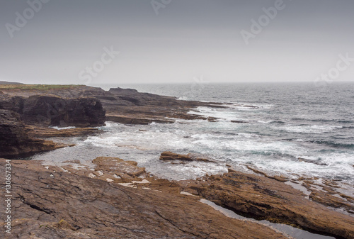 Waves crashing on large rocks at Hook Head, Wexford, Republic of Ireland.