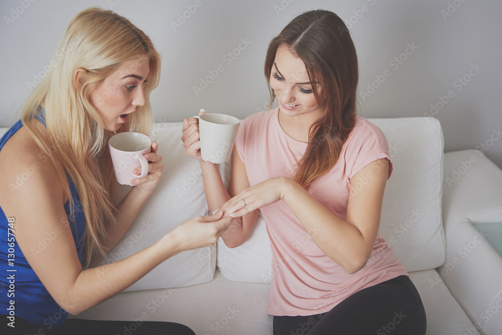 Fototapeta premium Girl surprised with her friend's engagement ring