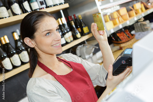 Shop assistant holding card payment machine and card