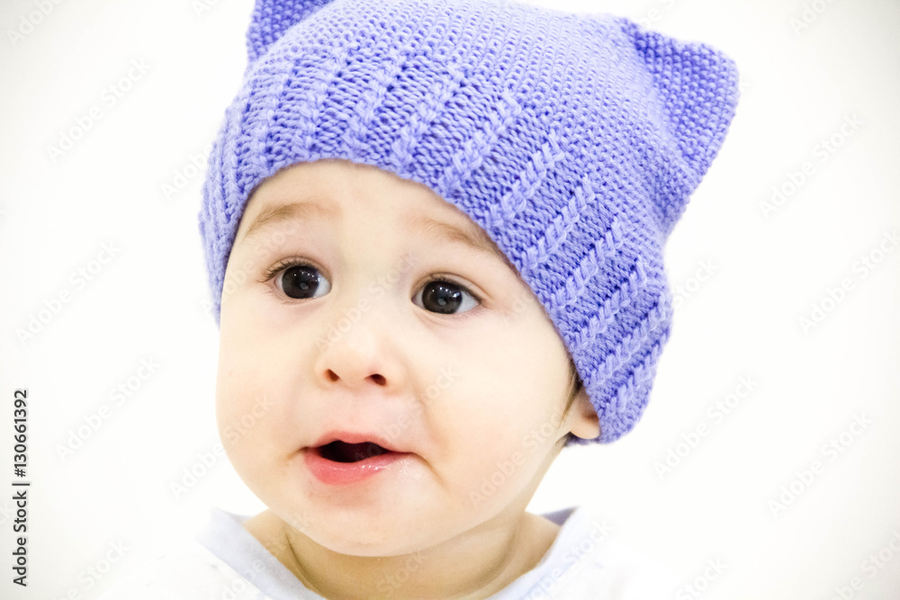 baby boy sitting on table with fruits and vegetables and eating an apple isolated on white background baby boy sitting on table with fruits and vegetables and eating an apple isolated on white background