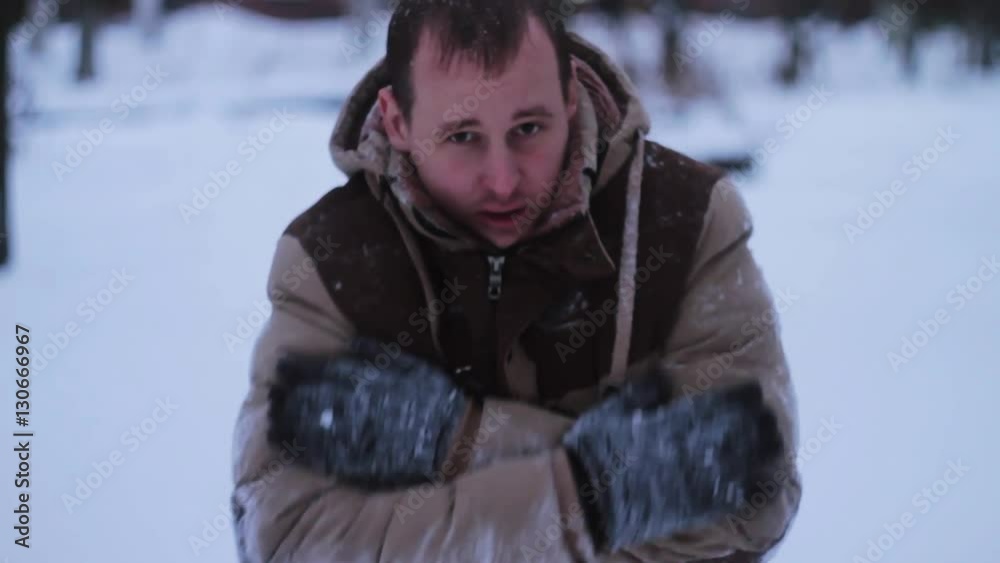 the young man basks in the winter against snow