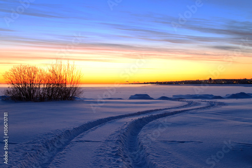 Beautiful winter sunrise with the way among the snow