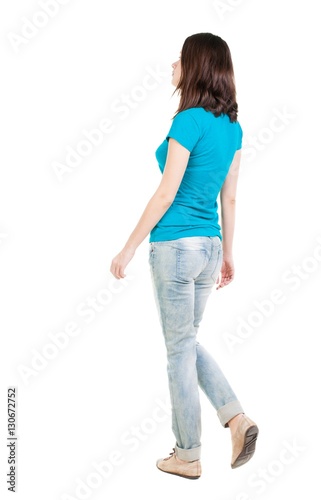 back view of walking  woman in jeans . © ghoststone