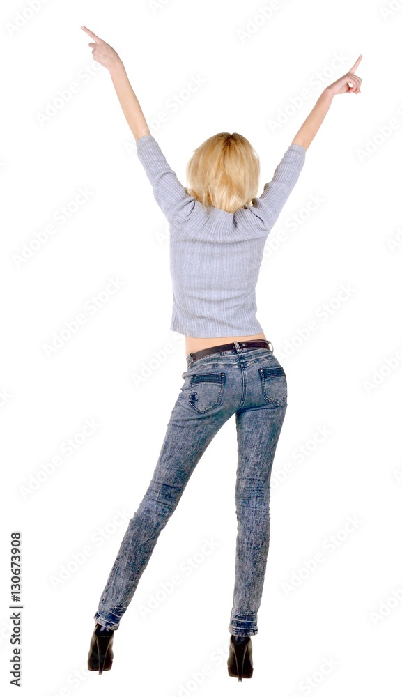 Beautiful young woman pointing at wall. Beautiful young woman pointing at wall.