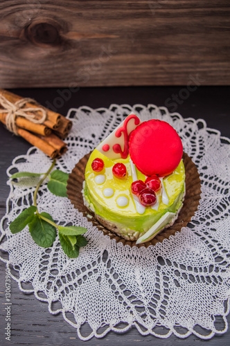 Cake with cream on a dark wood background. Top view. Close-up