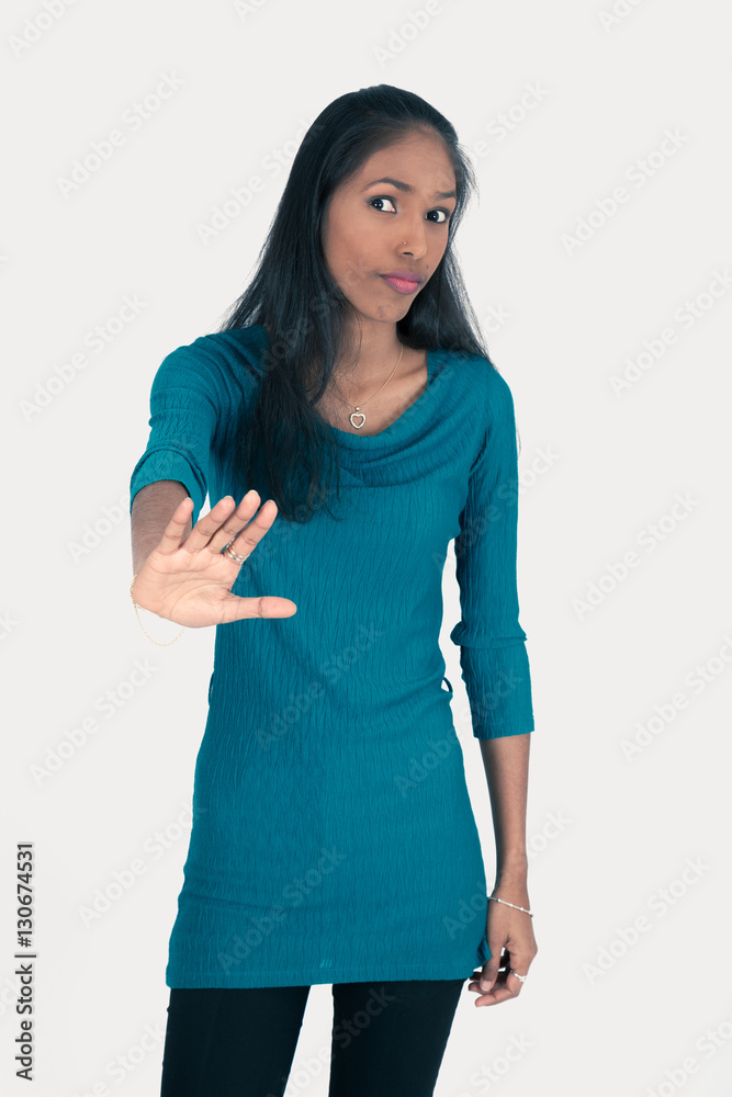 Beautiful woman doing different expressions in different sets of clothes: stop sign Beautiful woman doing different expressions in different sets of clothes: stop sign