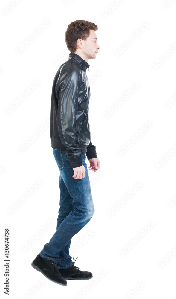 Back view of going handsome man in jacket. walking young guy Back view of going handsome man in jacket. walking young guy
