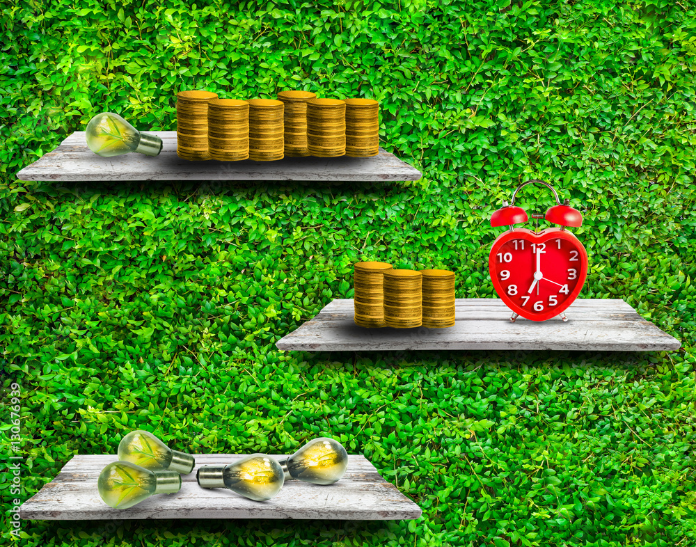 Gold coins with small tree in lamps and clock, Time idea and investment concept.