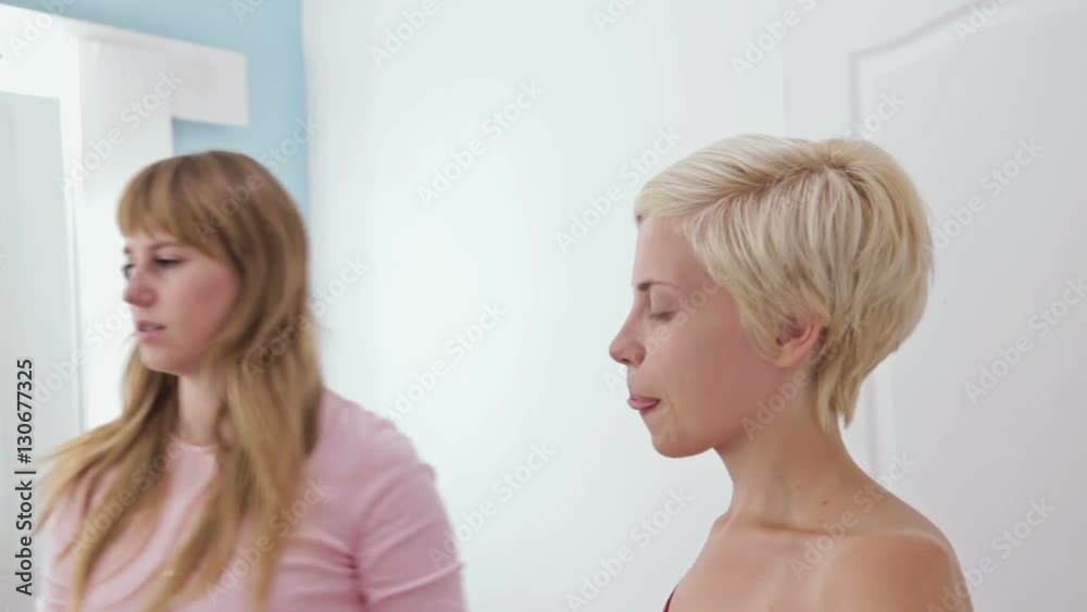 Professional make-up artist plucking eyebrows of client in white room. Beauty, spa and fashion concept Professional make-up artist plucking eyebrows of client in white room. Beauty, spa and fashion concept
