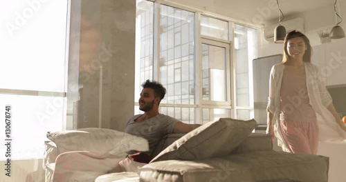 Mixed Race Couple Spending Time Together, Happy Smiling Asain Woman Hispanic Man Sitting Coach Morning Sunlight Slow Motion