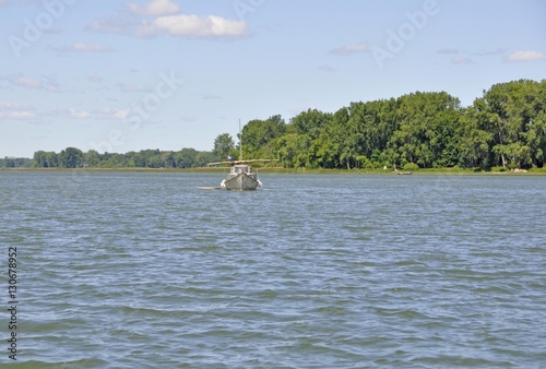  small fishing boat in the Saint Lawrence Iles des Sorel region near Sorel-Tracy, Quebec Canada  photo