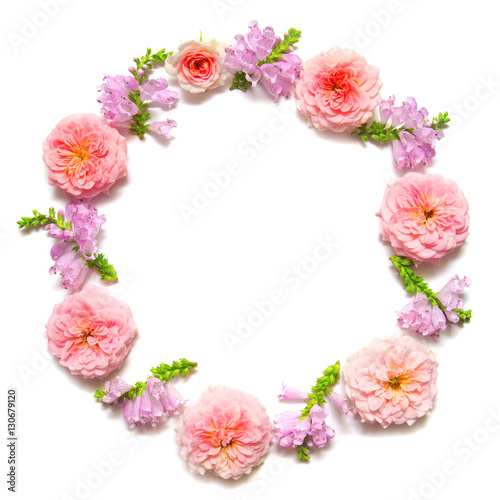 Wreath with leaves and flowers of pink roses isolated on white b