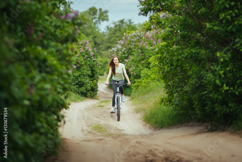 Happy girl cyclist riding on a mountain bike outside. Adventure travel. Girl cyclist. Mountain bike. healthy lifestyle. Sort concept.