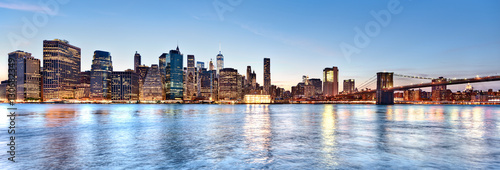New York City Manhattan skyline and cityscape at twilight with Brooklyn Bridge