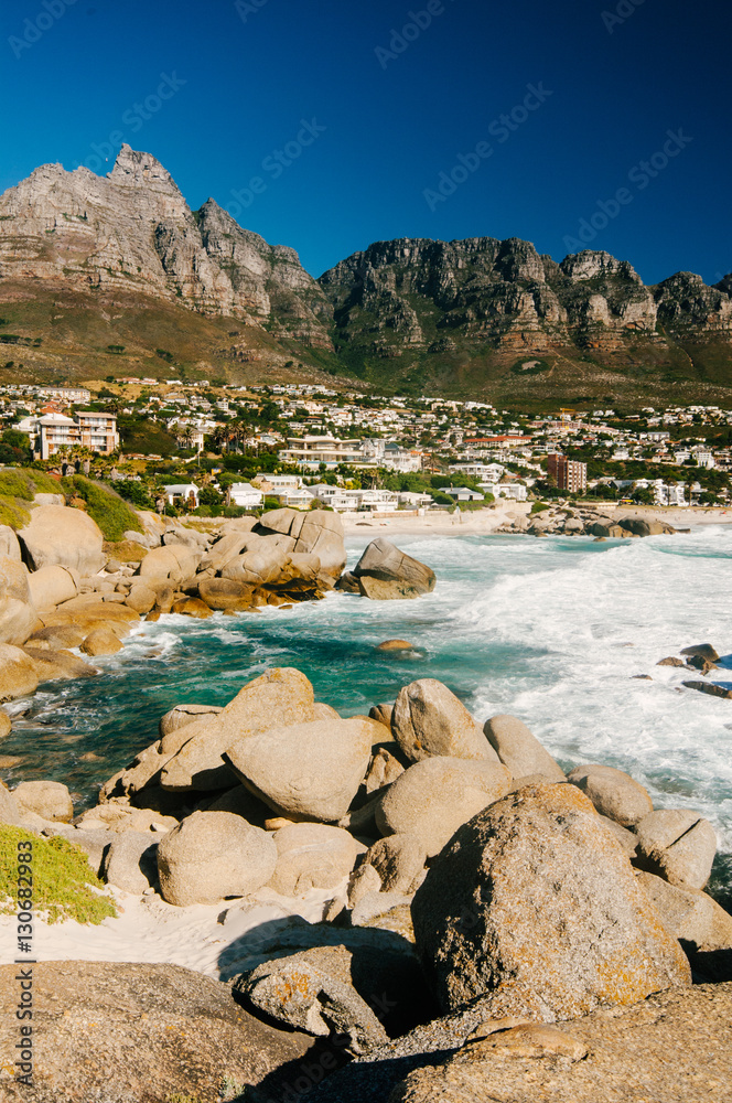 The coastal line of camps bay with the twelve apostle mountains behind it. Camps Bay is one of the most exclusive resort of south africa.