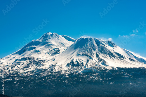 Snowcapped Mount Shasta volcano during winter blue closeup