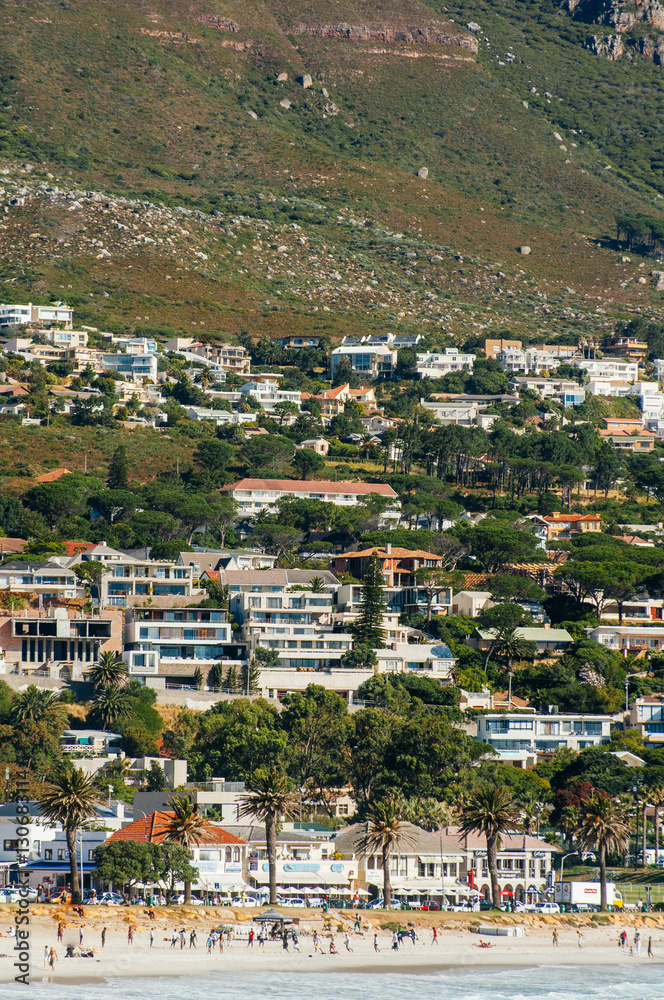 The coastal line of camps bay with the twelve apostle mountains behind it. Camps Bay is one of the most exclusive resort of south africa.