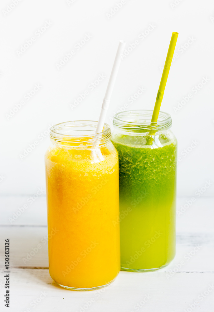 Fresh detox juices in glass bottles on white background Fresh detox juices in glass bottles on white background
