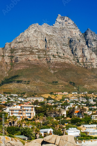 The coastal line of camps bay with the twelve apostle mountains behind it. Camps Bay is one of the most exclusive resort of south africa. © jon11
