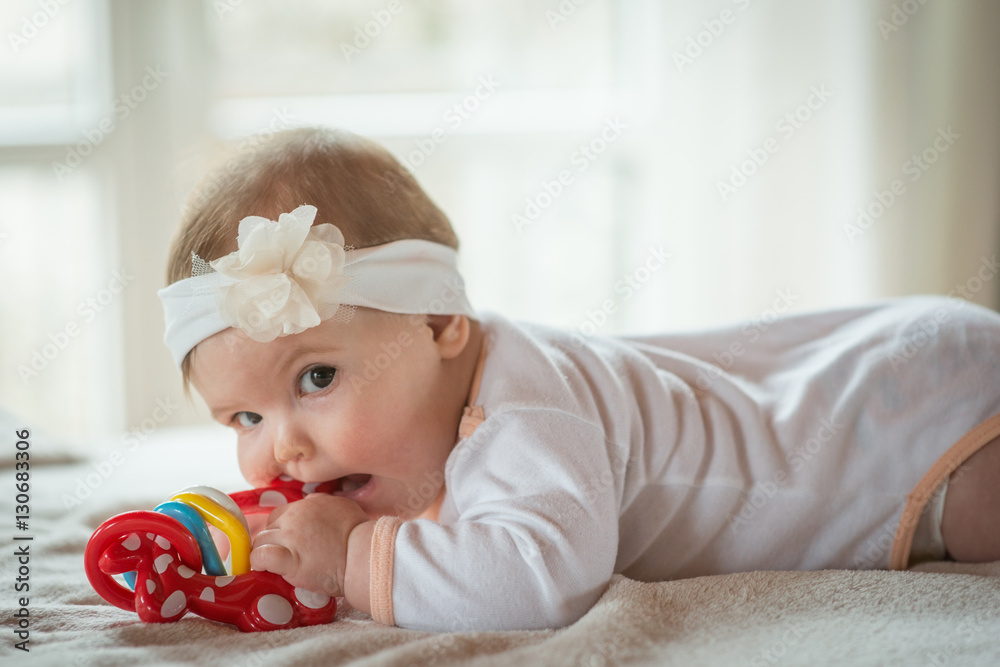Baby girl playing with mobile in the cradle Baby girl playing with mobile in the cradle