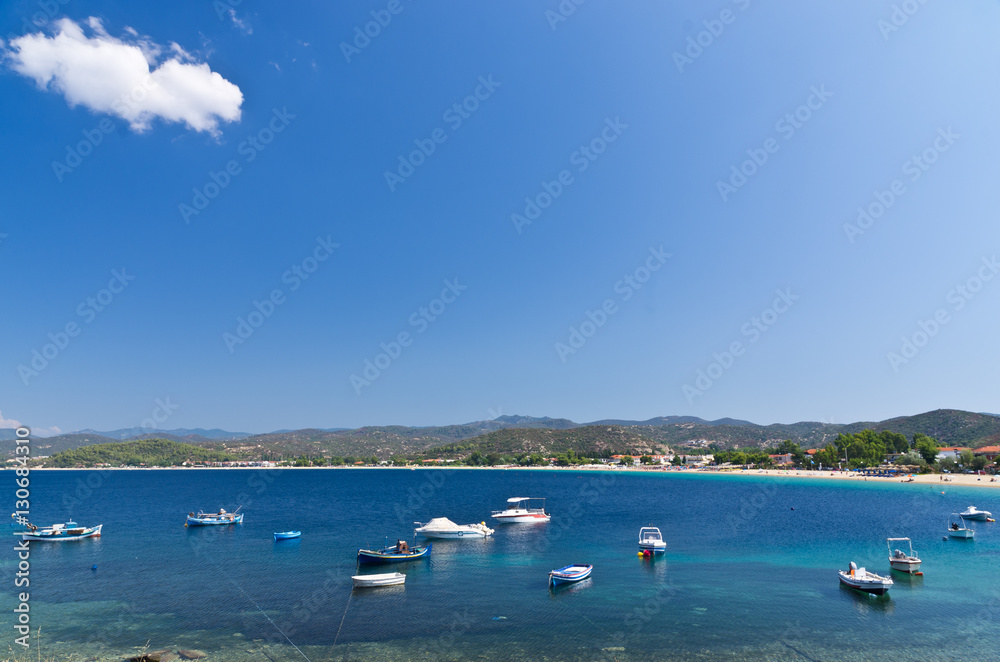 Boats in a small fishing harbour by the beach, Sithonia, Greece