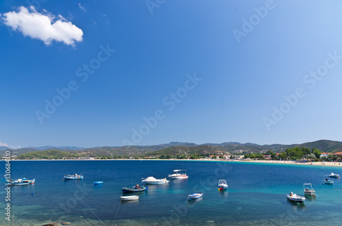 Boats in a small fishing harbour by the beach, Sithonia, Greece © banepetkovic