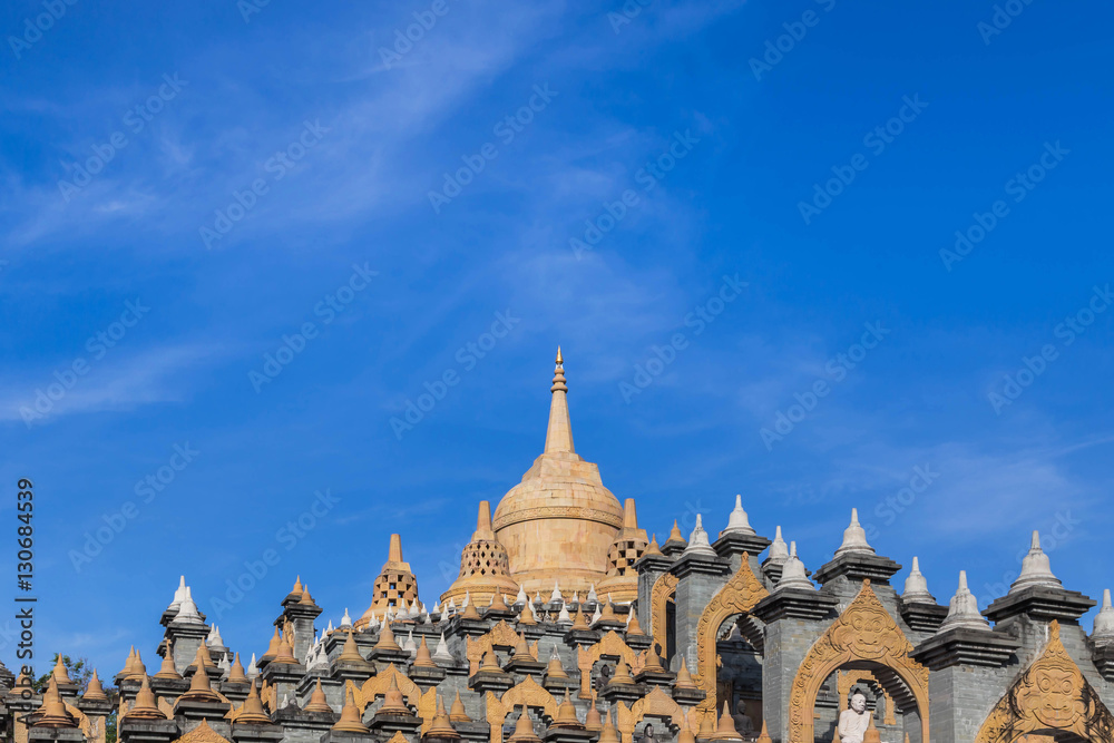 Fototapeta premium Sandstone pagoda in wat Pa Kung temple at Roi Et of Thailand on blue sky