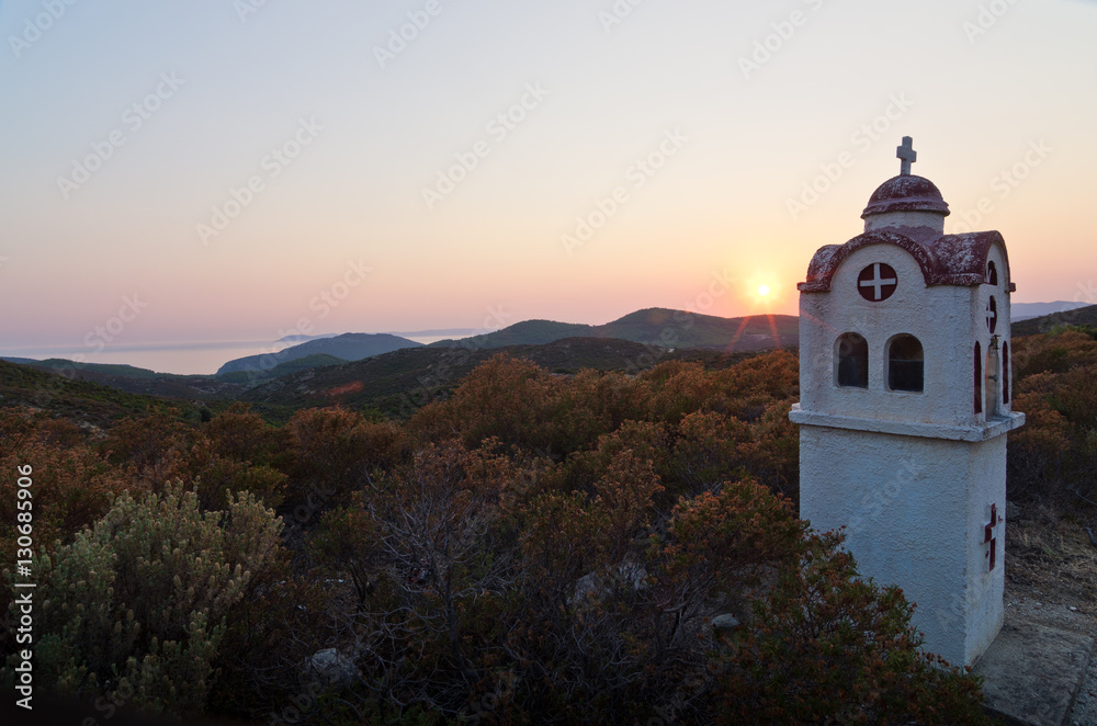 Small church or chapel with typical Greek landscape at sunset, Sithonia, Greece