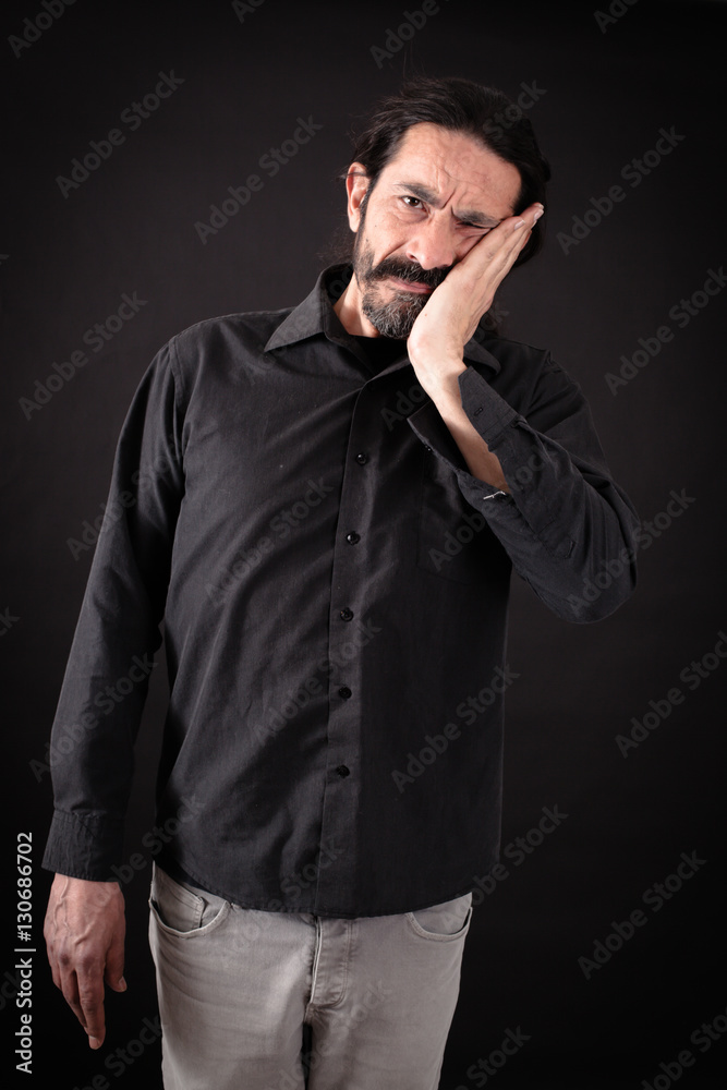 Obraz premium Handsome man doing different expressions in different sets of clothes: toothache