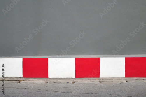 red and white colour on the side walk. selective focus