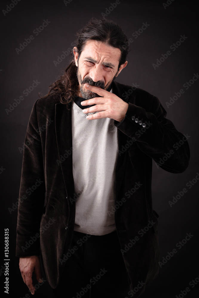 Handsome man doing different expressions in different sets of clothes: toothache Handsome man doing different expressions in different sets of clothes: toothache