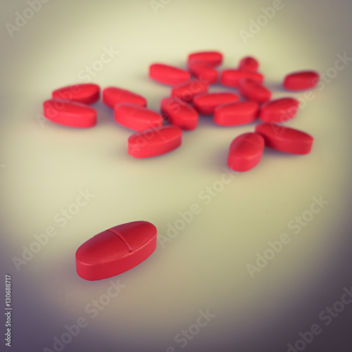 Red pills on gray background and shadow, vintage stye color