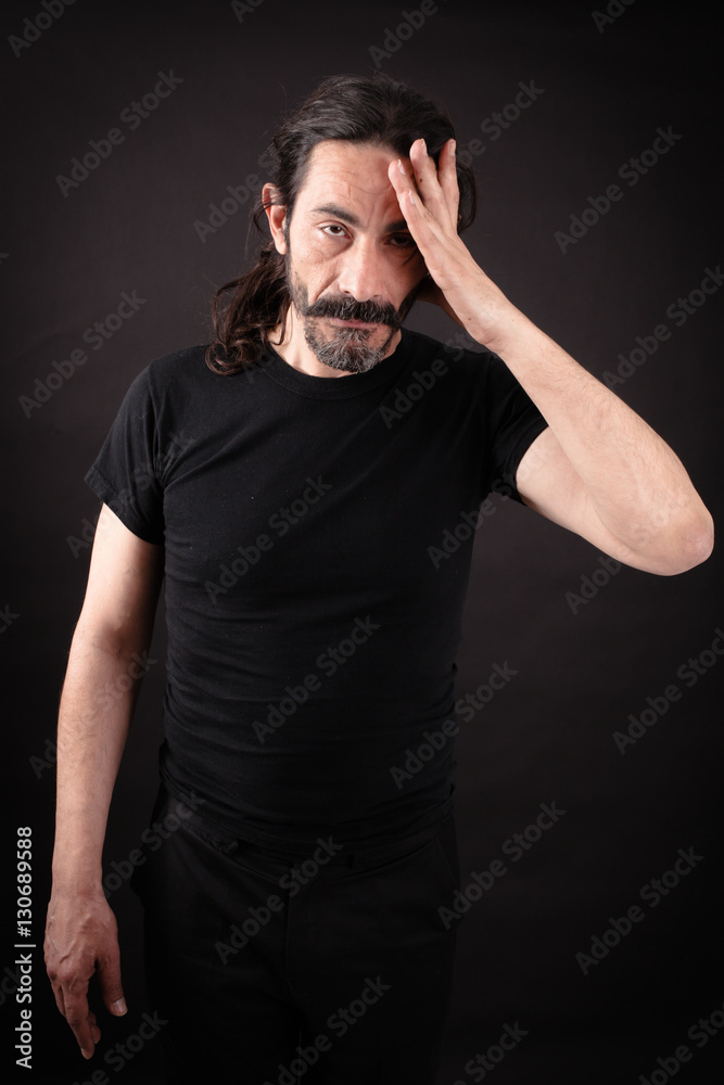 Handsome man doing different expressions in different sets of clothes: headache Handsome man doing different expressions in different sets of clothes: headache