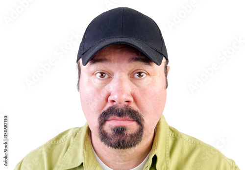 Portrait of staring man wearing baseball cap