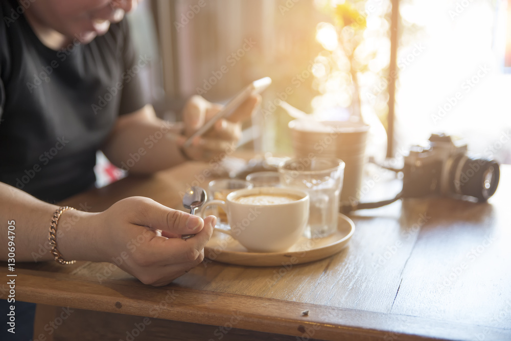 Coffee time, smart man using mobile phone in a cafe,on a table with coffee, camera and glasses. Coffee time, smart man using mobile phone in a cafe,on a table with coffee, camera and glasses.