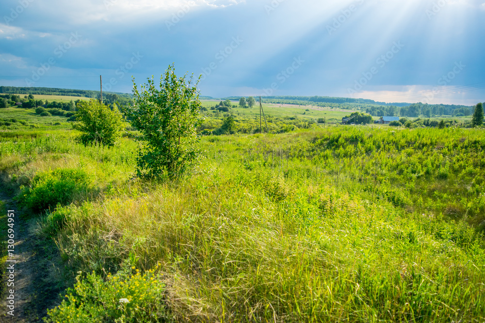Sun rays at storm sky under a velley