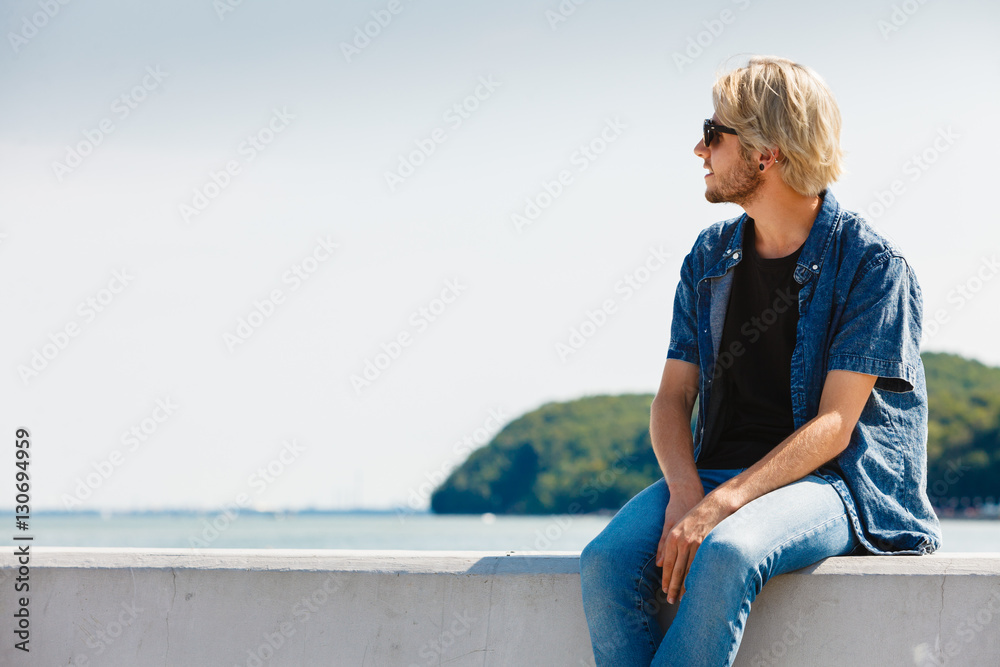 Fototapeta premium Sitting man relaxing, enjoying summertime