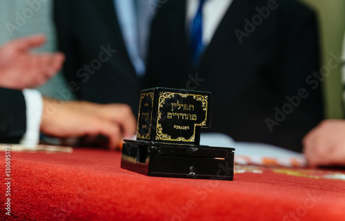 Hand of boy reading the Jewish Torah at Bar Mitzvah