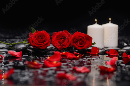 Still life with red rose with two candle and therapy stones 