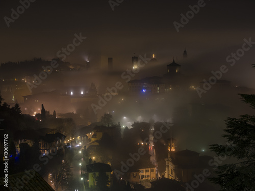 Bergamo - Old city (Città Alta). One of the beautiful city in Italy. Lombardia. The fog rises from the plains and wrap all the old city by creating lighting effects.