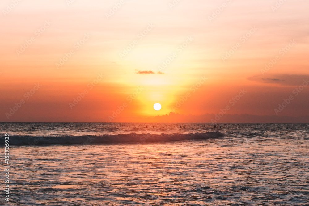 Sunset on the beach with surfers, Indonesia, Bali