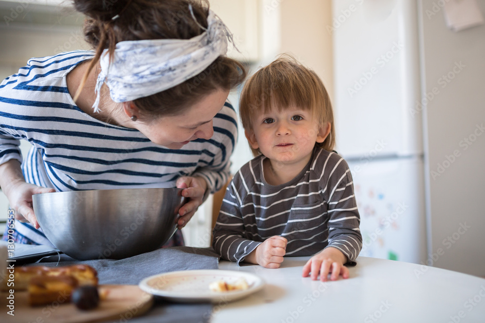 young pregnant mother with son Toddler, make dough for baking young pregnant mother with son Toddler, make dough for baking