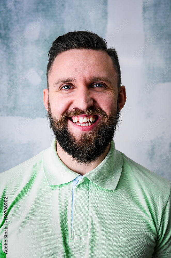 Fototapeta premium Portrait of young adult bearded happy man looking at camera