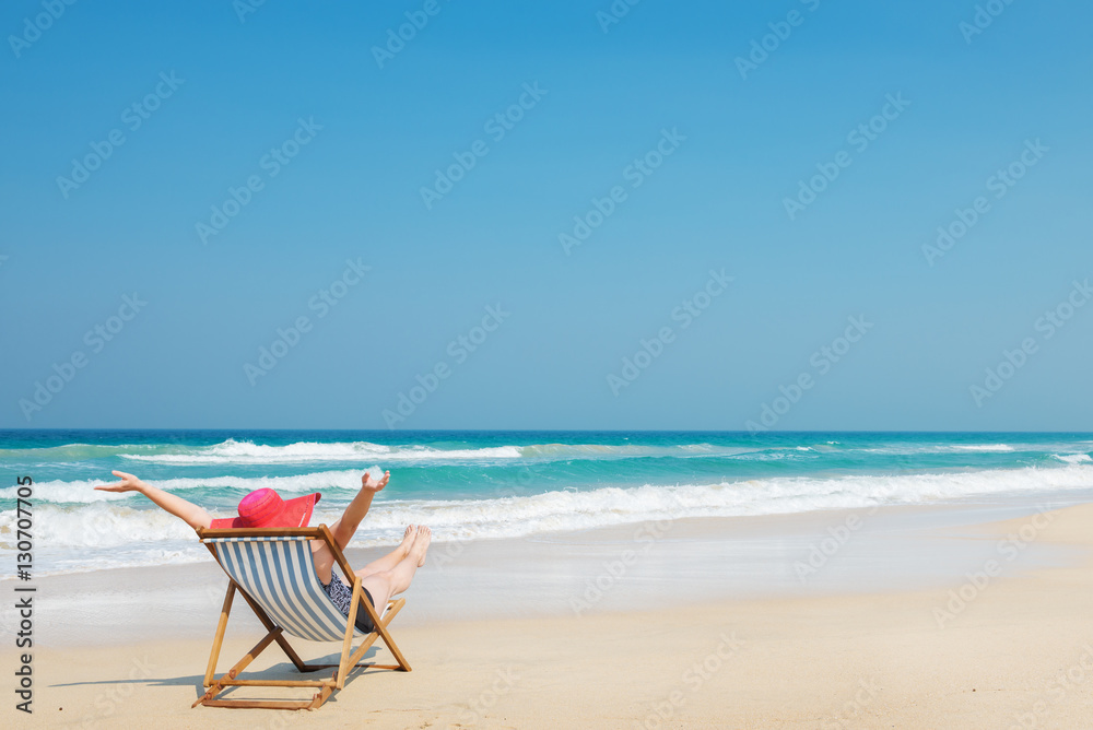 Happy woman in red sunhat on the beach Happy woman in red sunhat on the beach
