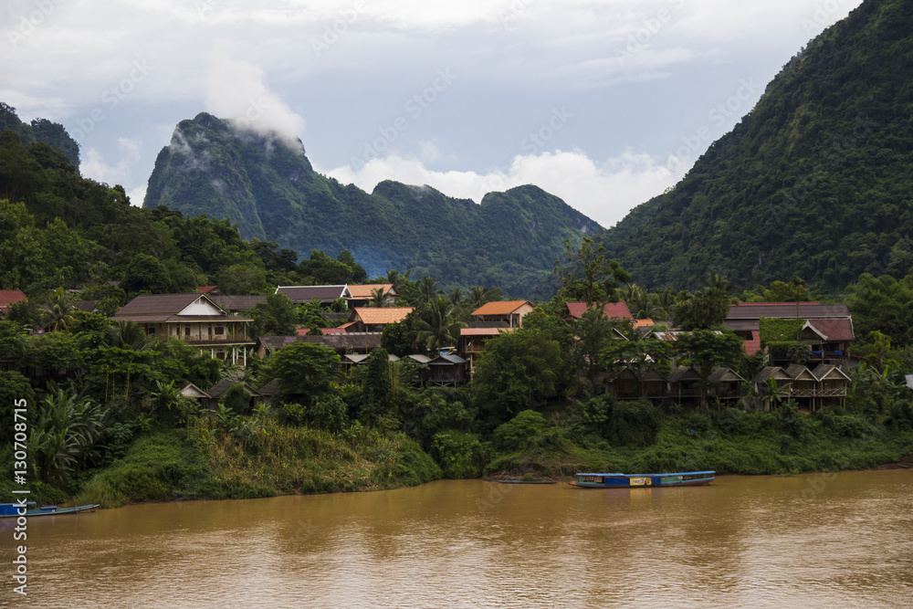 Naklejka premium Village on the riverbank in Laos
