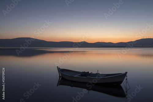 Beautiful sunset with fishing boat © Suzi