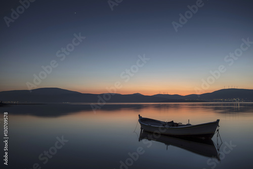Beautiful sunset with fishing boat © Suzi
