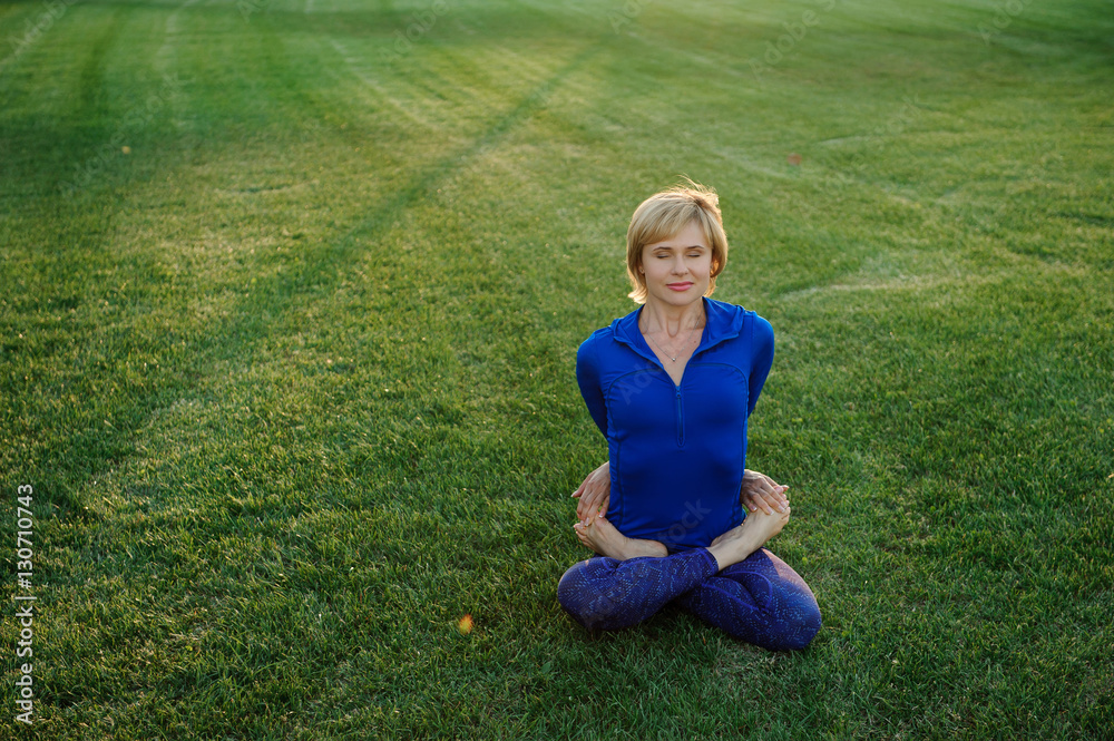 beautiful woman doing yoga exercises in park beautiful woman doing yoga exercises in park