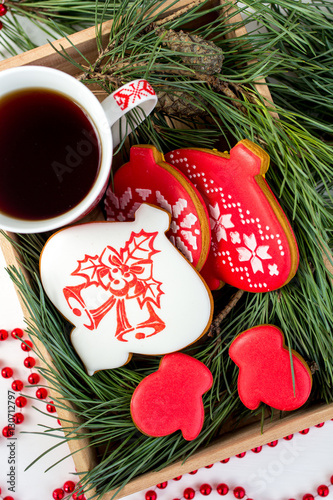 Fototapeta Naklejka Na Ścianę i Meble -  Ginger biscuits and a Cup of tea on the table with branches of s