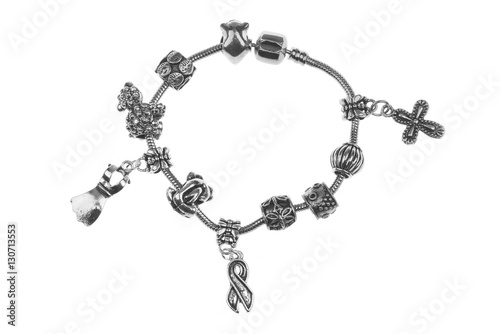 Small silver charm bracelet with many charms isolated on white background